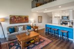 Living area and kitchen with uplifting colors